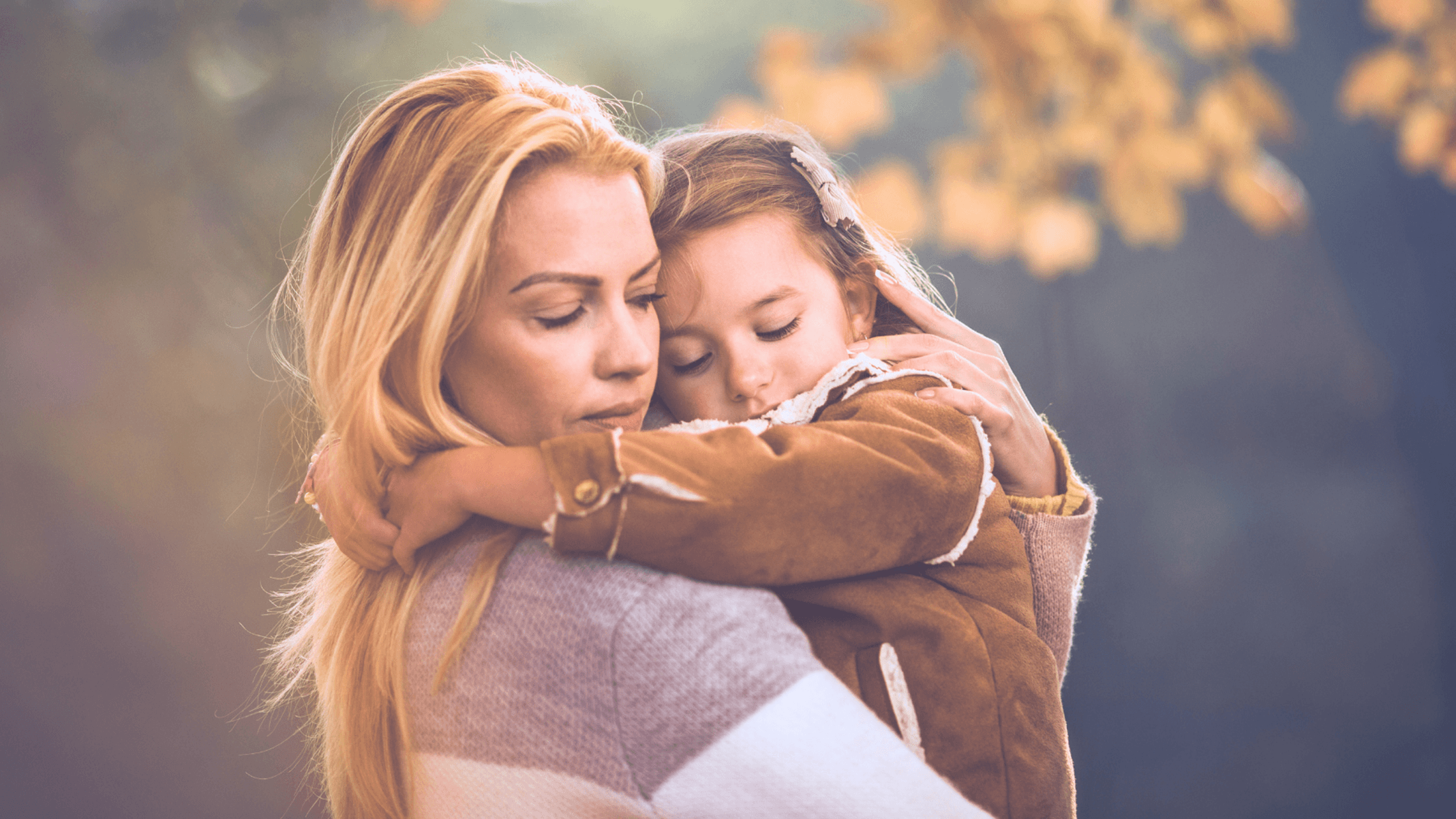 A mother comforting her young daughter, representing the trauma-informed care at Abuse Counseling & Therapy.