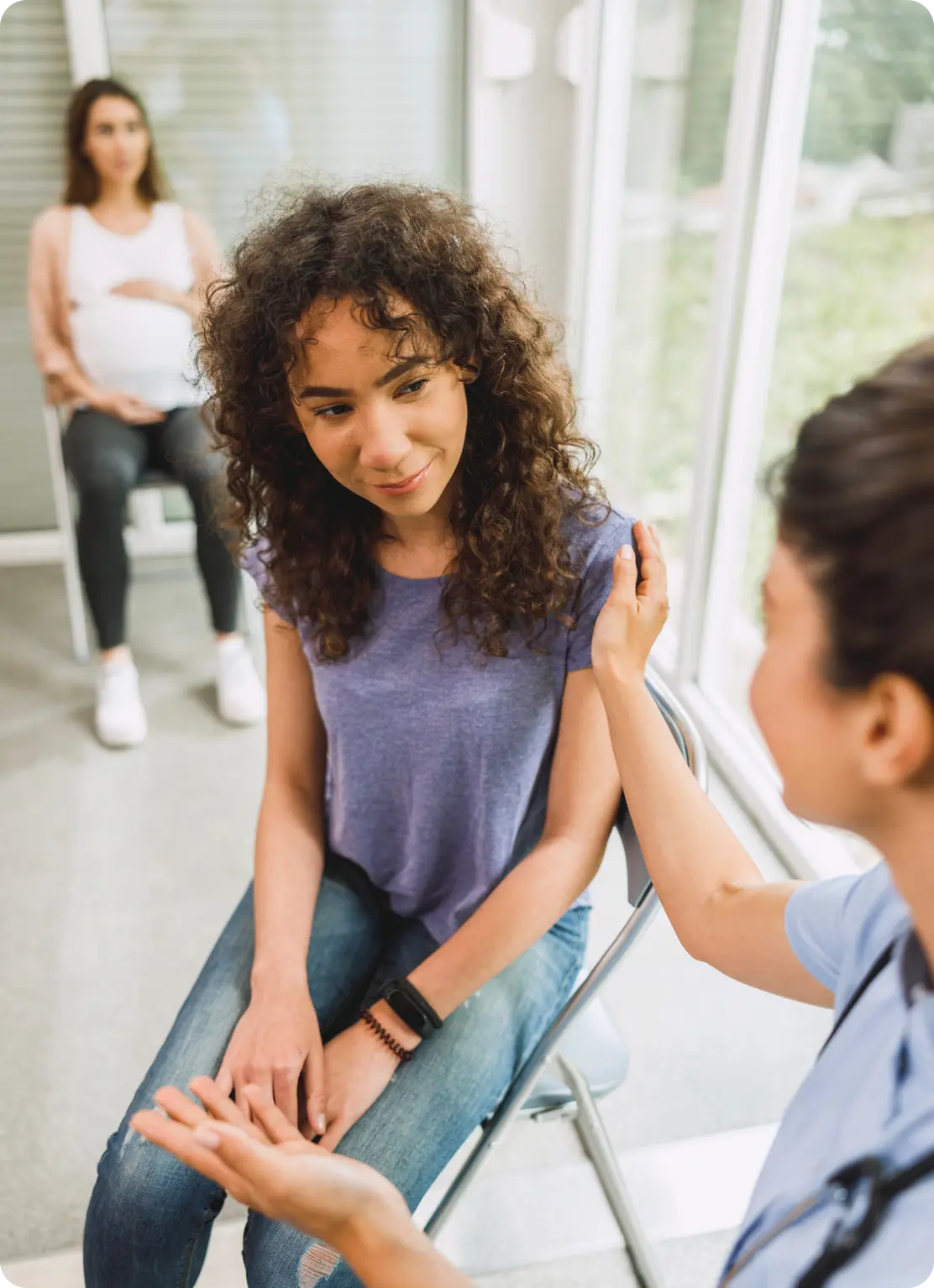 A counselor at Abuse Counseling & Therapy comforts a young woman during a supportive therapy session.