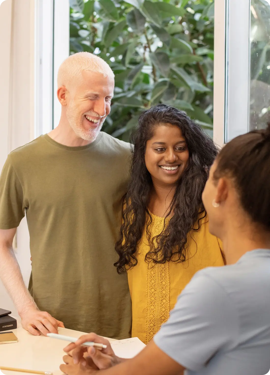 A smiling couple meets with a counselor at Abuse Counseling & Therapy.