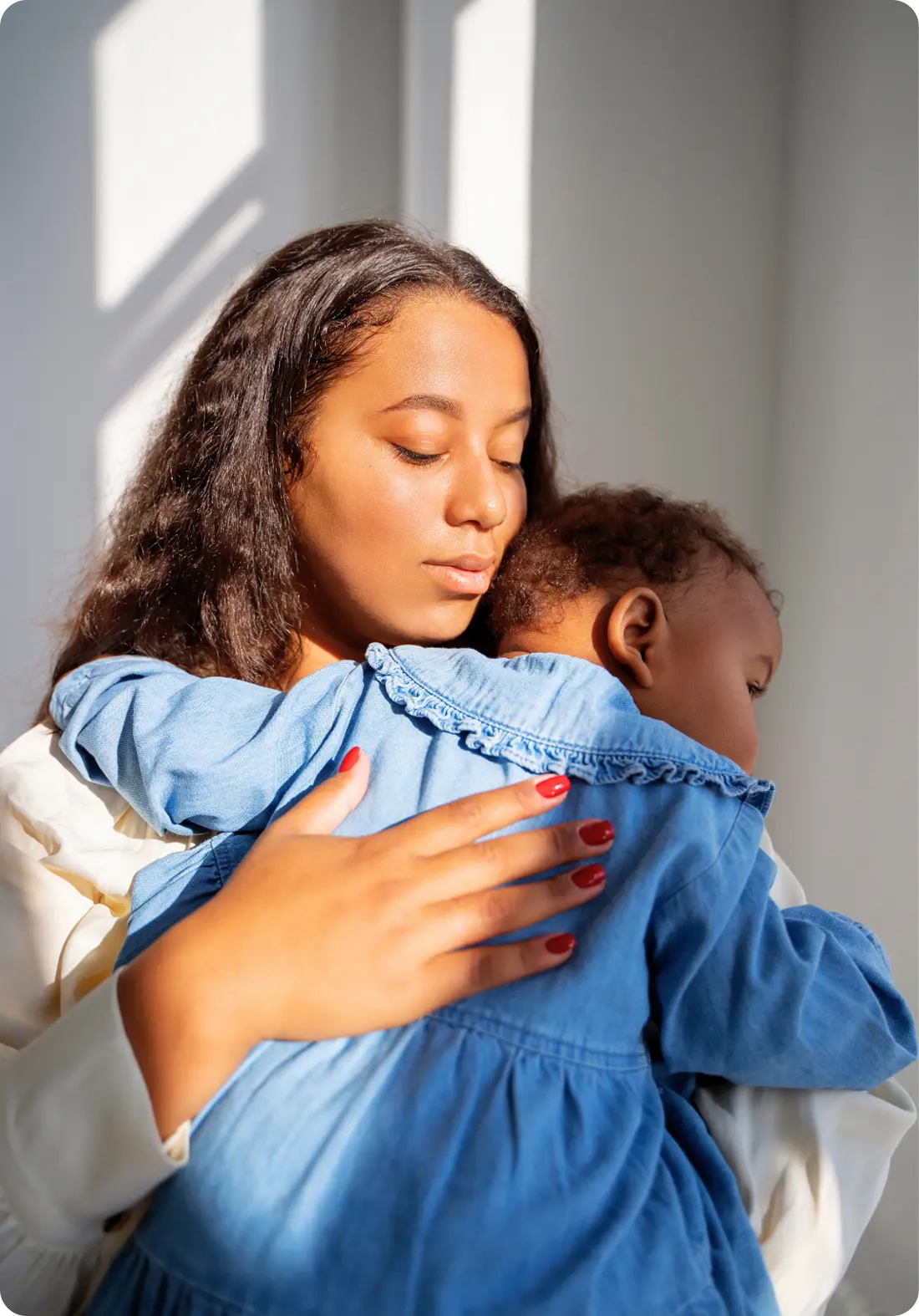 A woman tenderly embraces her baby, representing the safe, healing care at Abuse Counseling & Therapy.