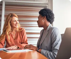 A counselor at Abuse Counseling & Therapy smiles during a supportive, one-on-one session with a client.