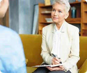 An Abuse Counseling & Therapy counselor listens compassionately to a client during a session.