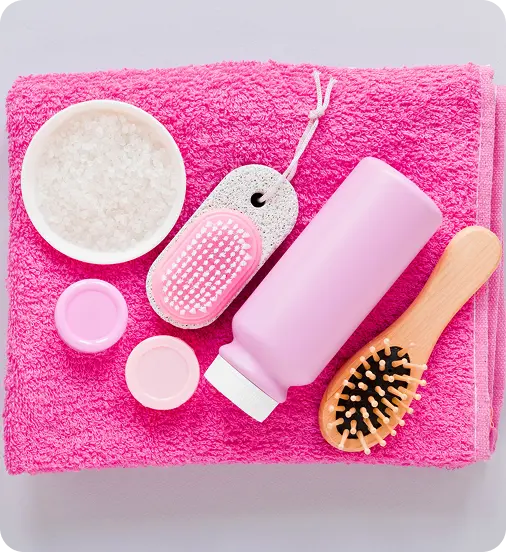 Pink self-care items on a towel, representing holistic healing at Abuse Counseling & Therapy.