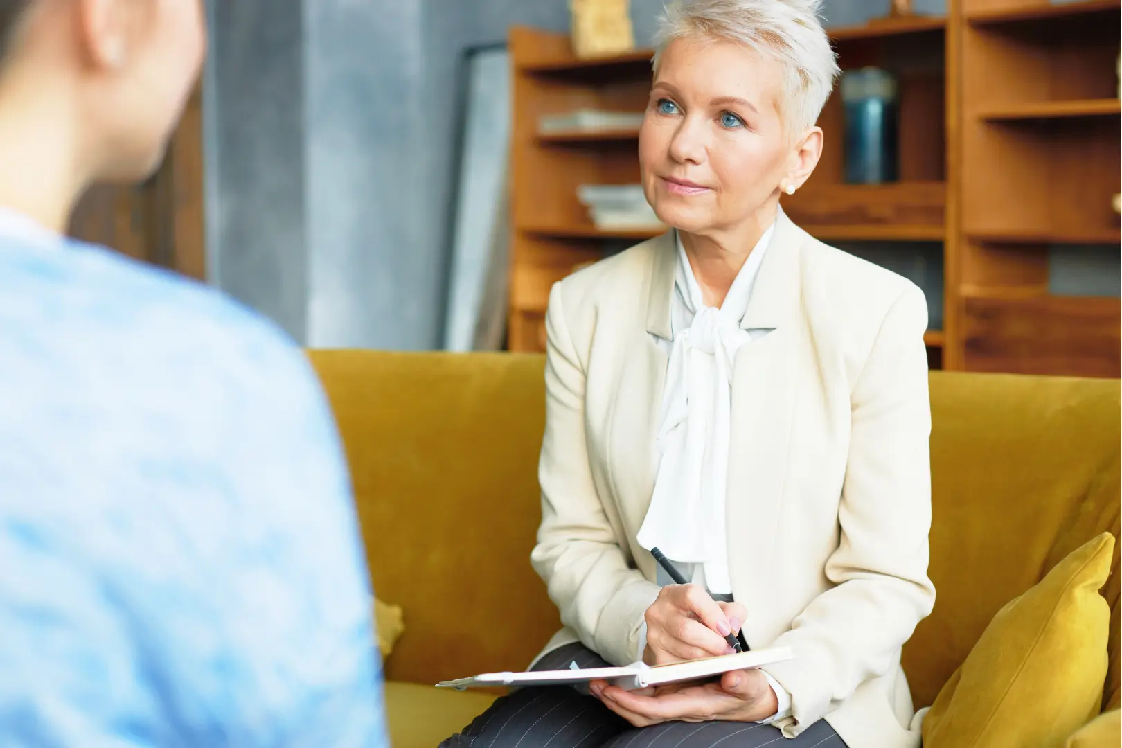 An Abuse Counseling & Therapy counselor listens attentively to a client during a session.