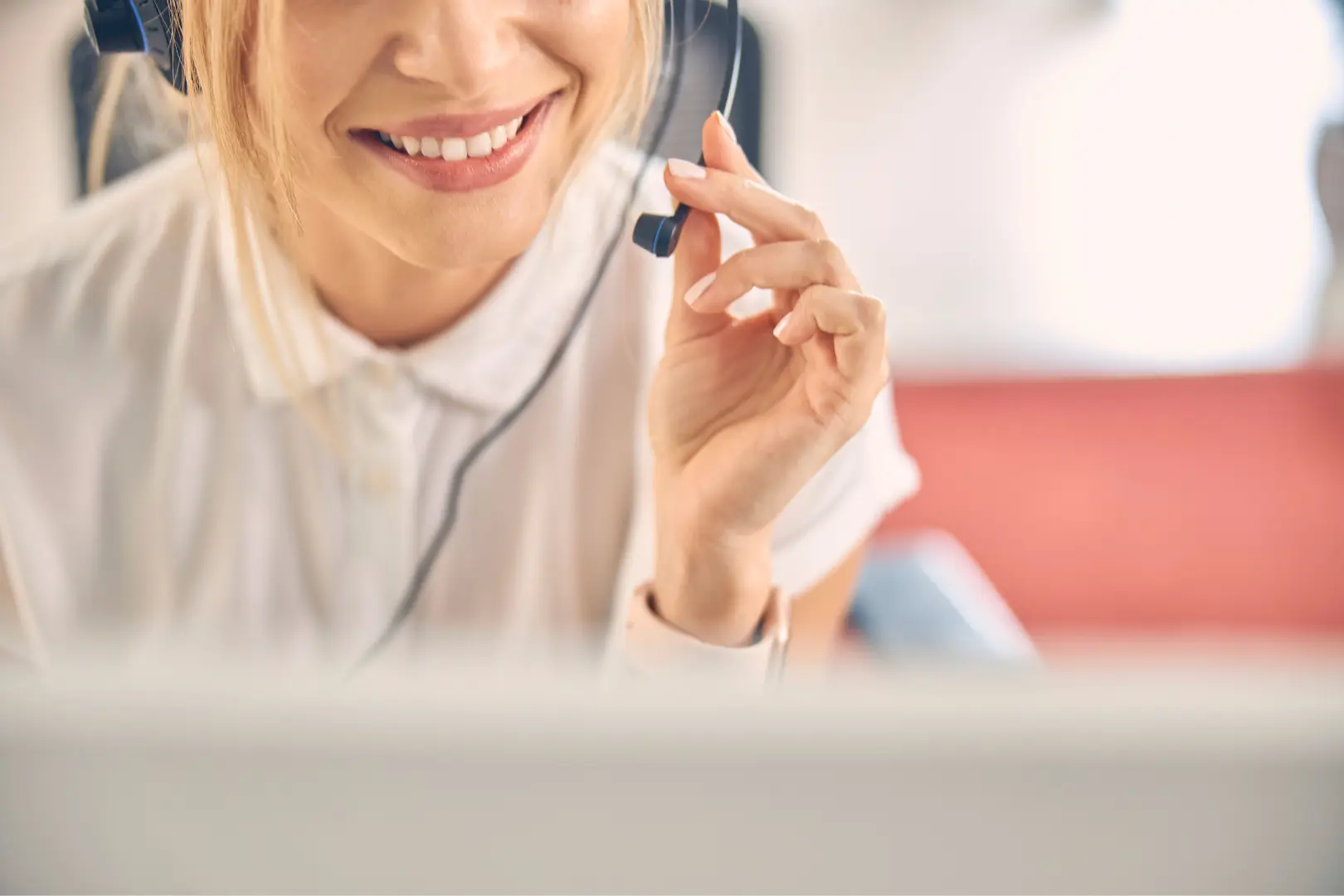 An Abuse Counseling & Therapy counselor smiles while wearing a headset to provide compassionate support.