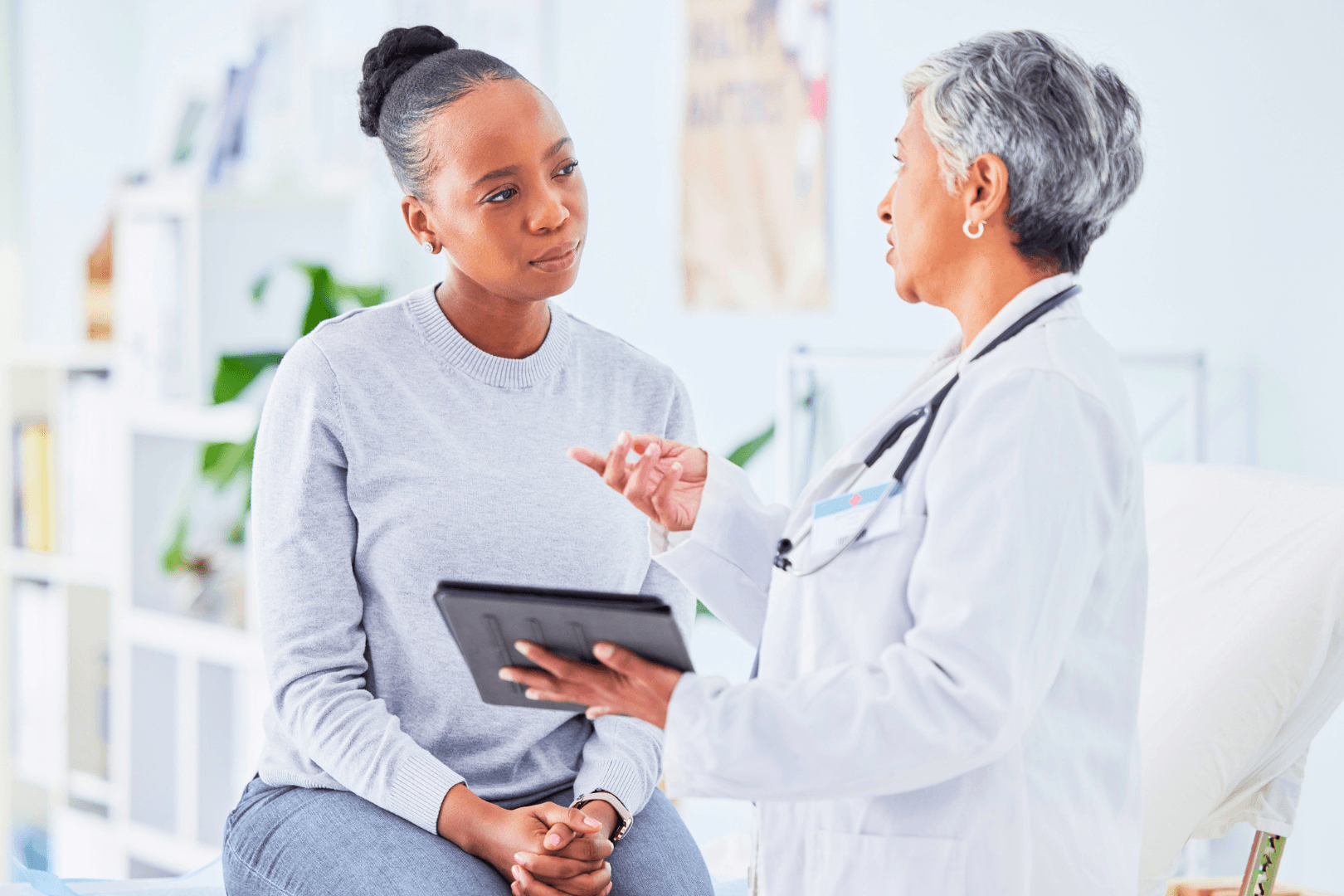 An Abuse Counseling & Therapy provider discusses care with a patient in a clinic.