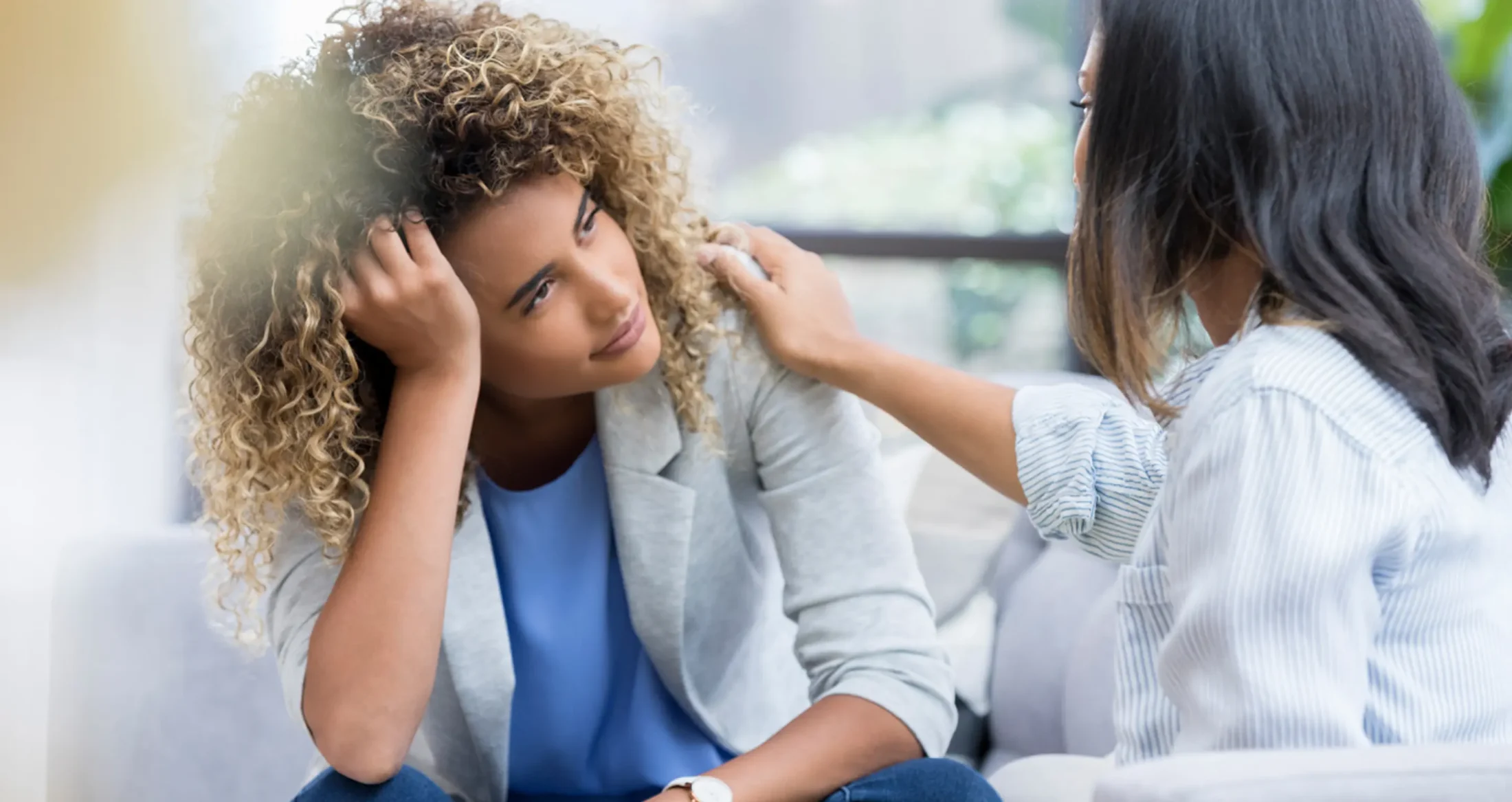 An Abuse Counseling & Therapy counselor comforts a distressed woman during a supportive session.