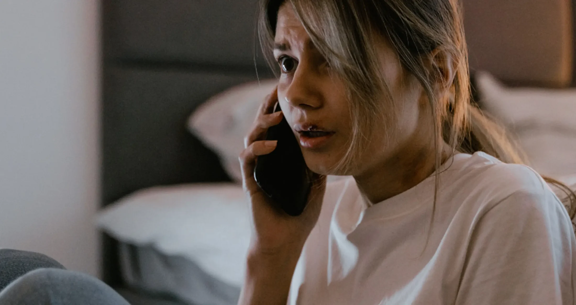 A distressed woman with a cut lip contacts Abuse Counseling & Therapy for support.