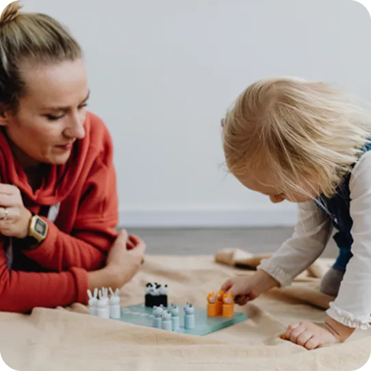 A young child engages in play therapy with a supportive counselor at Abuse Counseling & Therapy.