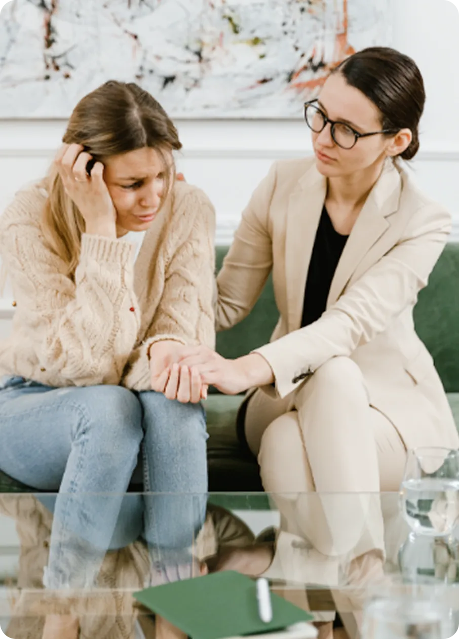 An Abuse Counseling & Therapy counselor comforts a distressed woman during a supportive therapy session.