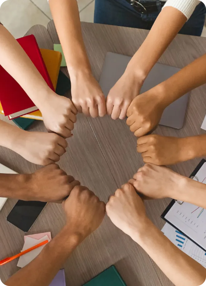 Diverse hands join in a circle of support at Abuse Counseling & Therapy.