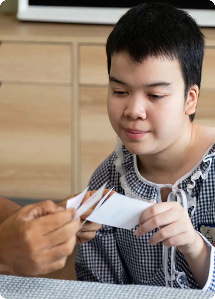 A youth reviews cards with a counselor during an Abuse Counseling & Therapy session.