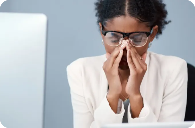 A stressed woman holding her face represents survivors supported by Abuse Counseling & Therapy.