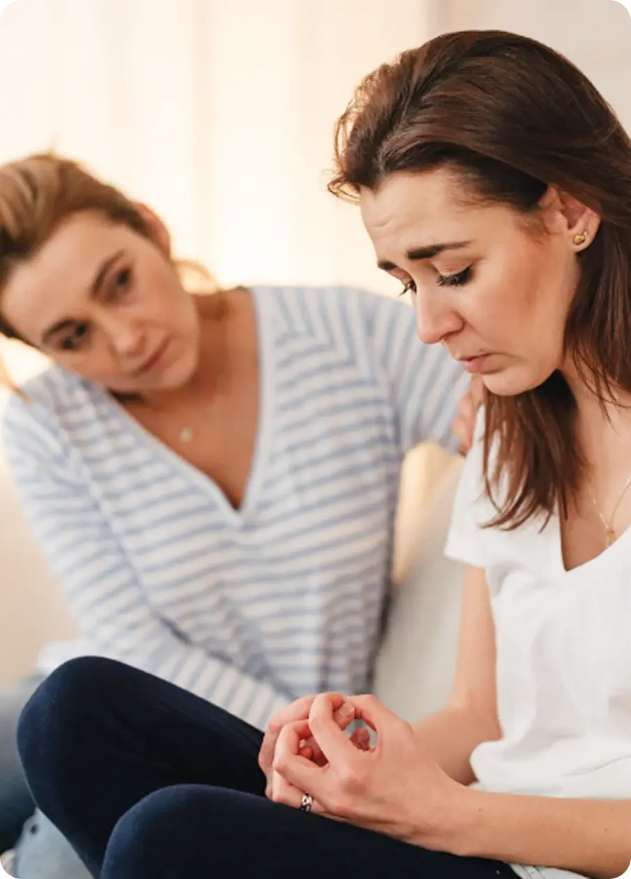 An Abuse Counseling & Therapy counselor comforts a distressed woman during a session.