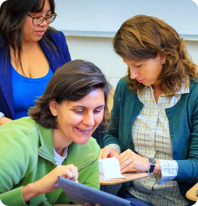Three women collaborate during an Abuse Counseling & Therapy support group session.