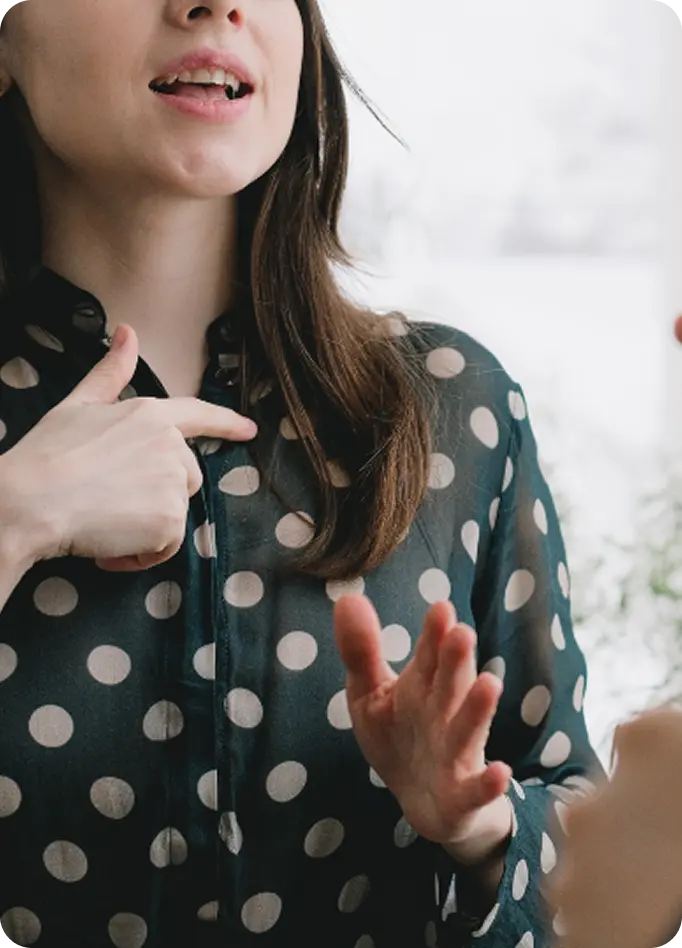 A woman uses sign language to communicate during a session at Abuse Counseling & Therapy.