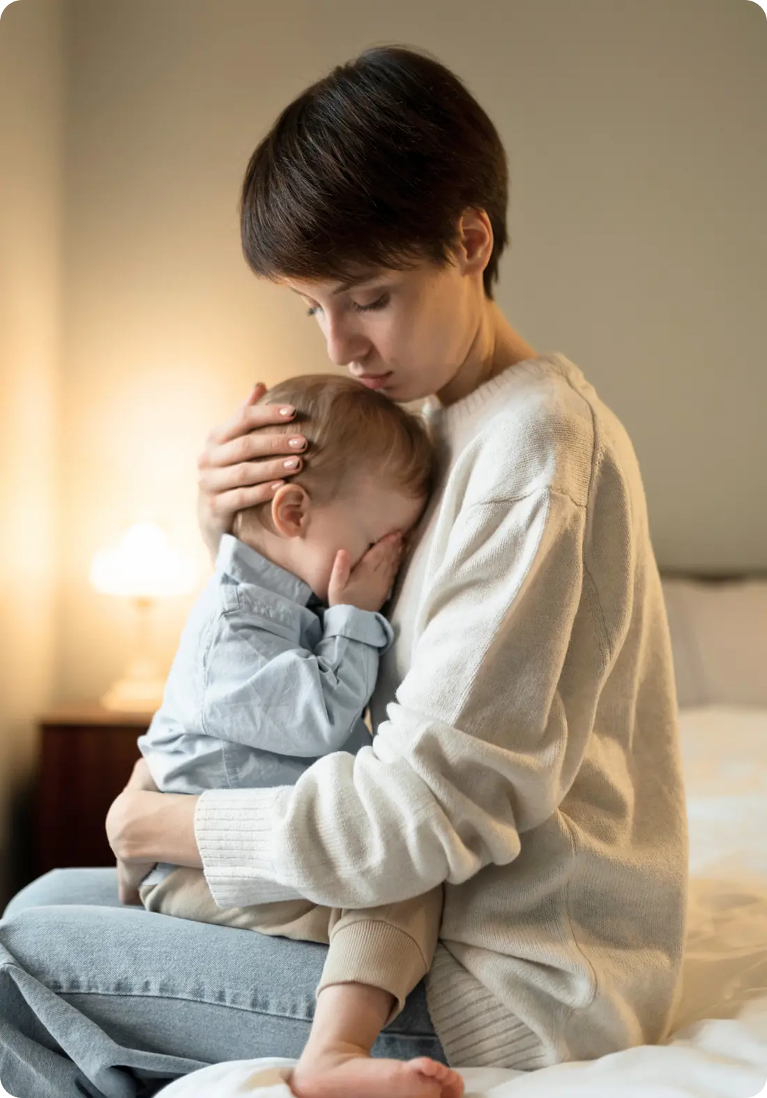 A mother comforts her crying toddler, illustrating family support from Abuse Counseling & Therapy.
