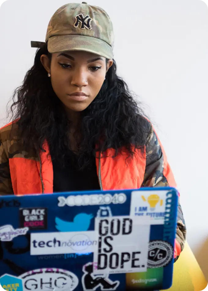 A young woman uses her laptop to connect with Abuse Counseling & Therapy for free, confidential support.