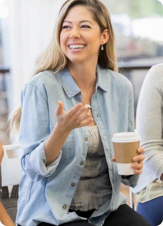 A smiling woman speaks during a support group session at Abuse Counseling & Therapy.