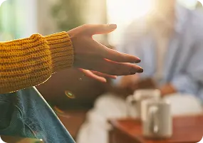 A client gestures during a supportive session at Abuse Counseling & Therapy.