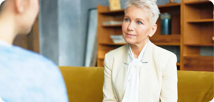 An Abuse Counseling & Therapy counselor listens supportively to a client during a session.