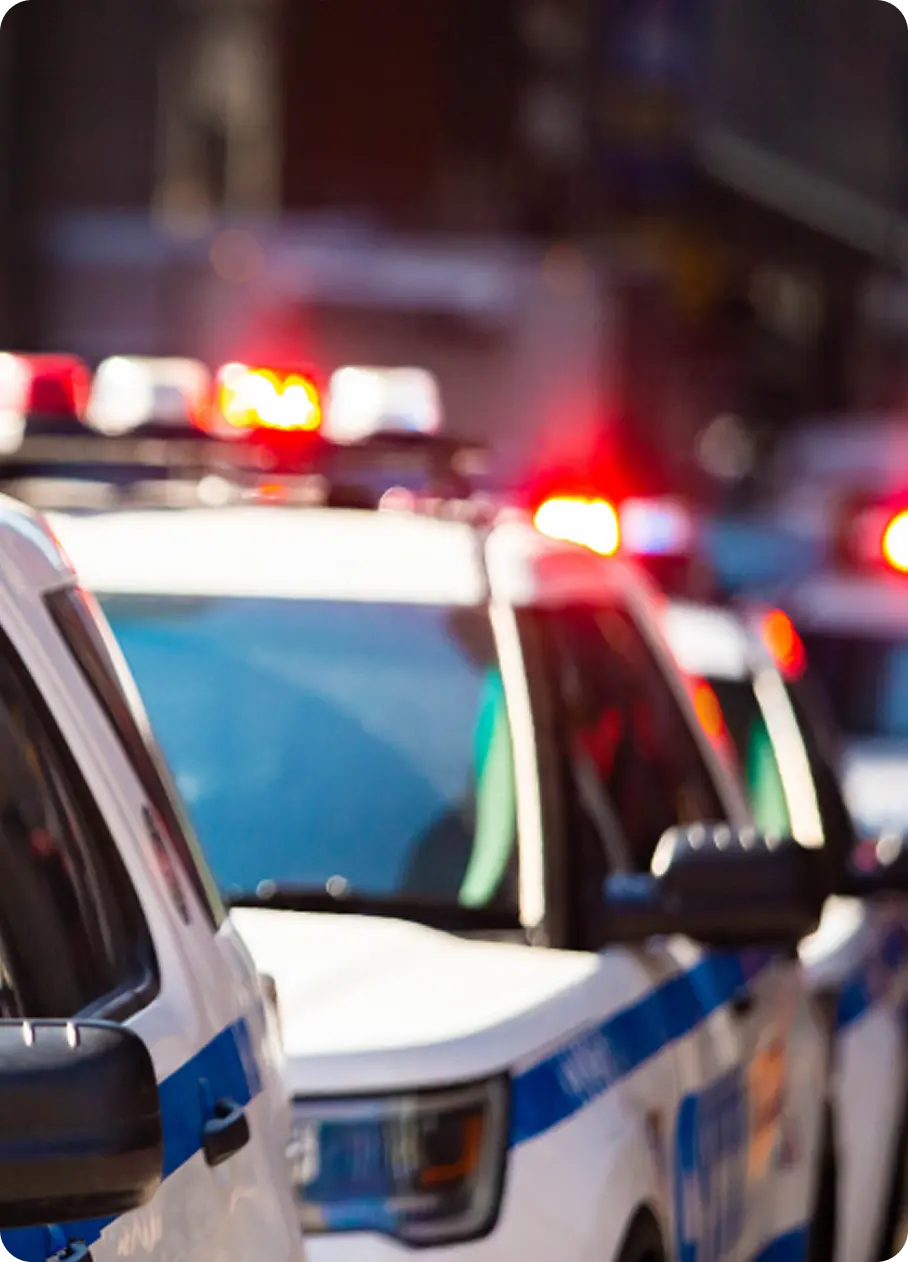 Flashing lights on police cars, representing emergency response and Abuse Counseling & Therapy crisis services.