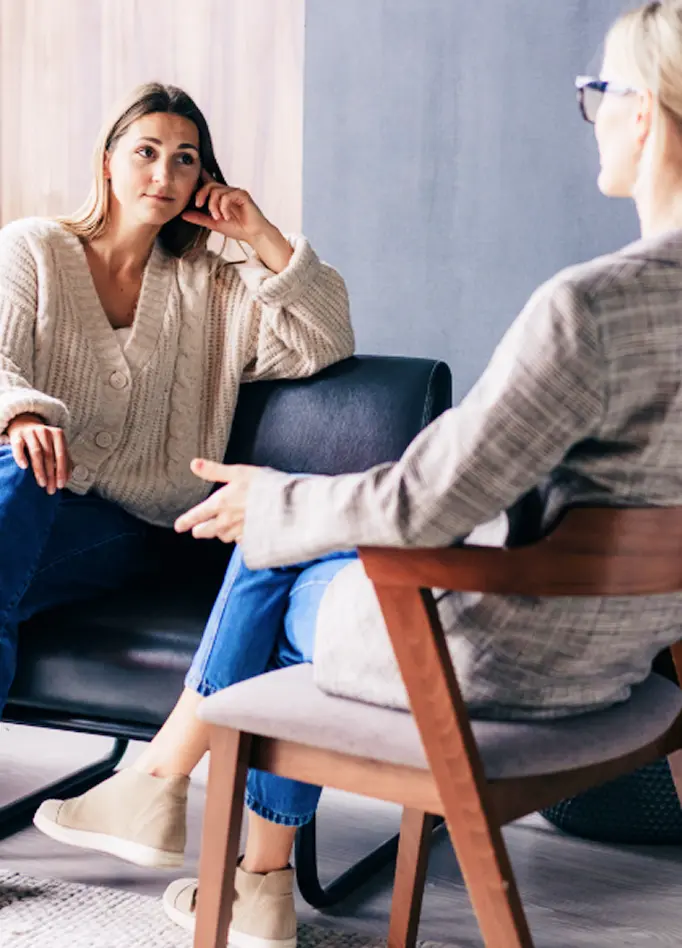 A client listens attentively to a therapist during a session at Abuse Counseling & Therapy.