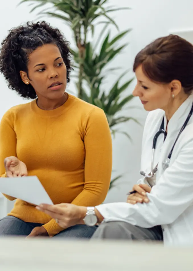 A client reviews documents with an Abuse Counseling & Therapy specialist during a supportive consultation.