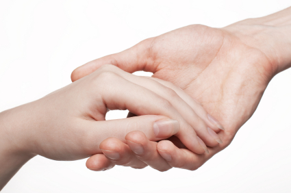 Two hands gently holding each other to represent support from Abuse Counseling & Therapy.